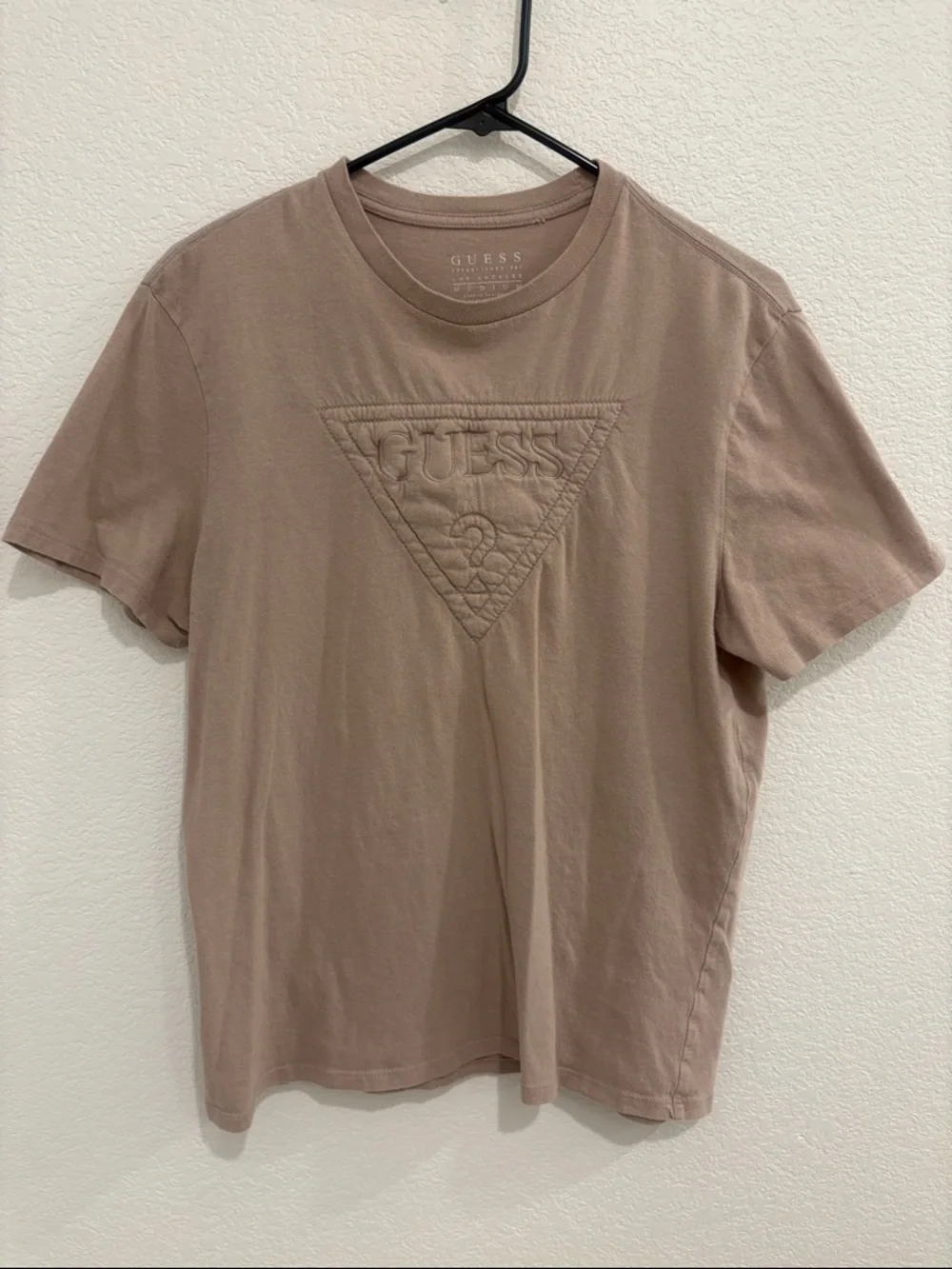GUESS Men’s Embossed Logo Short Sleeve Tee in Taupe - Picture 1 of 4
